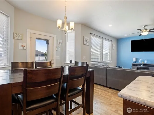a view of a dining room with furniture and window