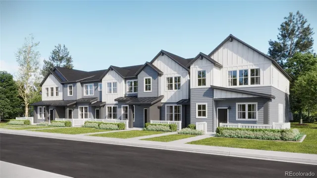 a front view of residential houses with yard and green space