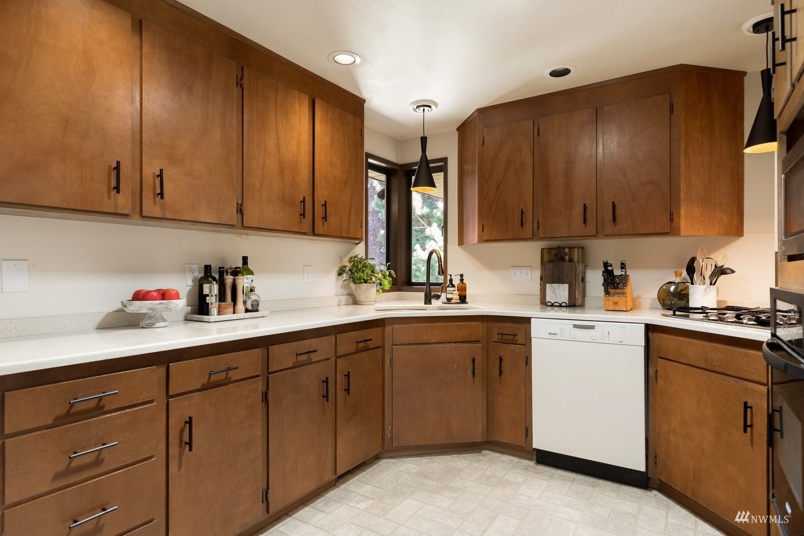 495 East Crescent Harbor Road Oak Harbor, WA 98277 - Photo 12 of 40 a kitchen with a sink dishwasher stove and cabinets