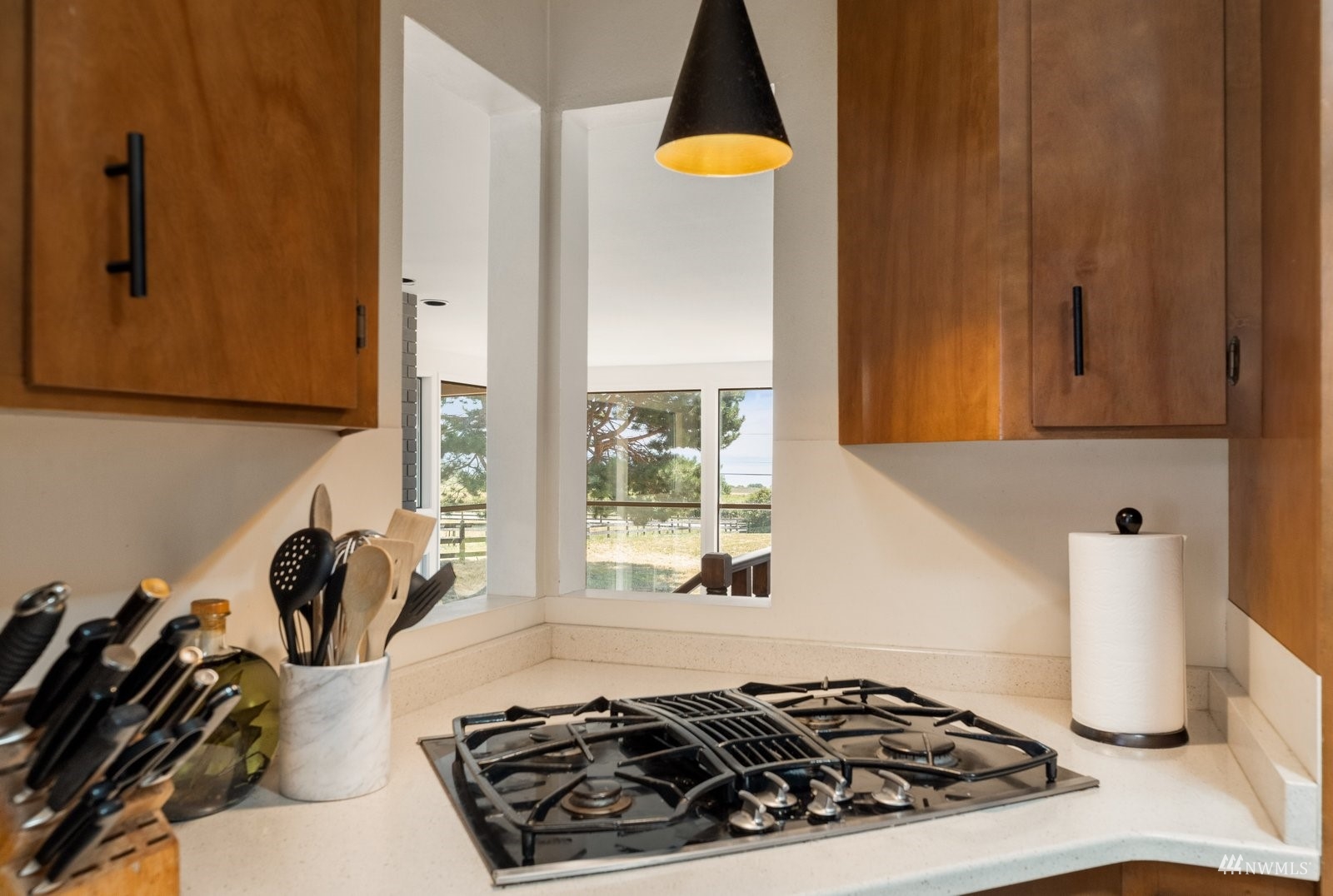 495 East Crescent Harbor Road Oak Harbor, WA 98277 - Photo 13 of 40 a kitchen with a stove and a wooden cabinets