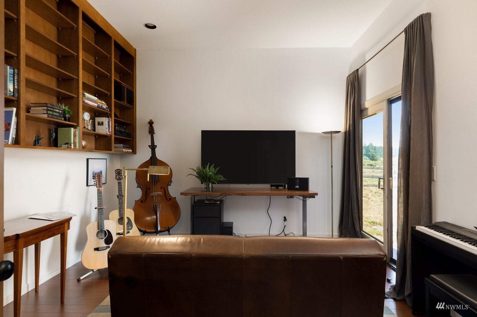 495 East Crescent Harbor Road Oak Harbor, WA 98277 - Photo 17 of 40 a bedroom with a bed and a flat screen tv