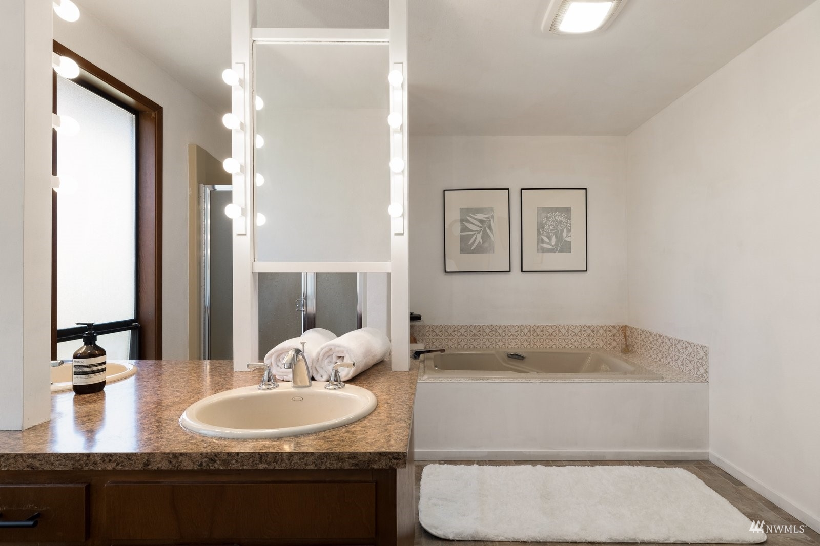 495 East Crescent Harbor Road Oak Harbor, WA 98277 - Photo 22 of 40 a bathroom with a granite countertop sink and a mirror