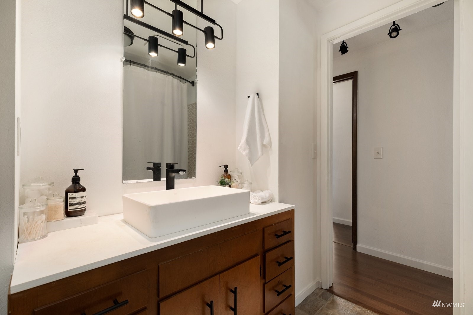 495 East Crescent Harbor Road Oak Harbor, WA 98277 - Photo 24 of 40 a bathroom with a sink a mirror and a shower