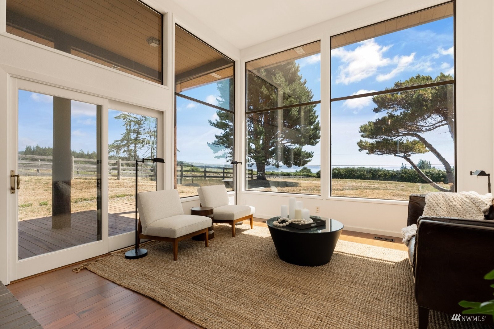 495 East Crescent Harbor Road Oak Harbor, WA 98277 - Photo 5 of 40 a living room with large window and a table