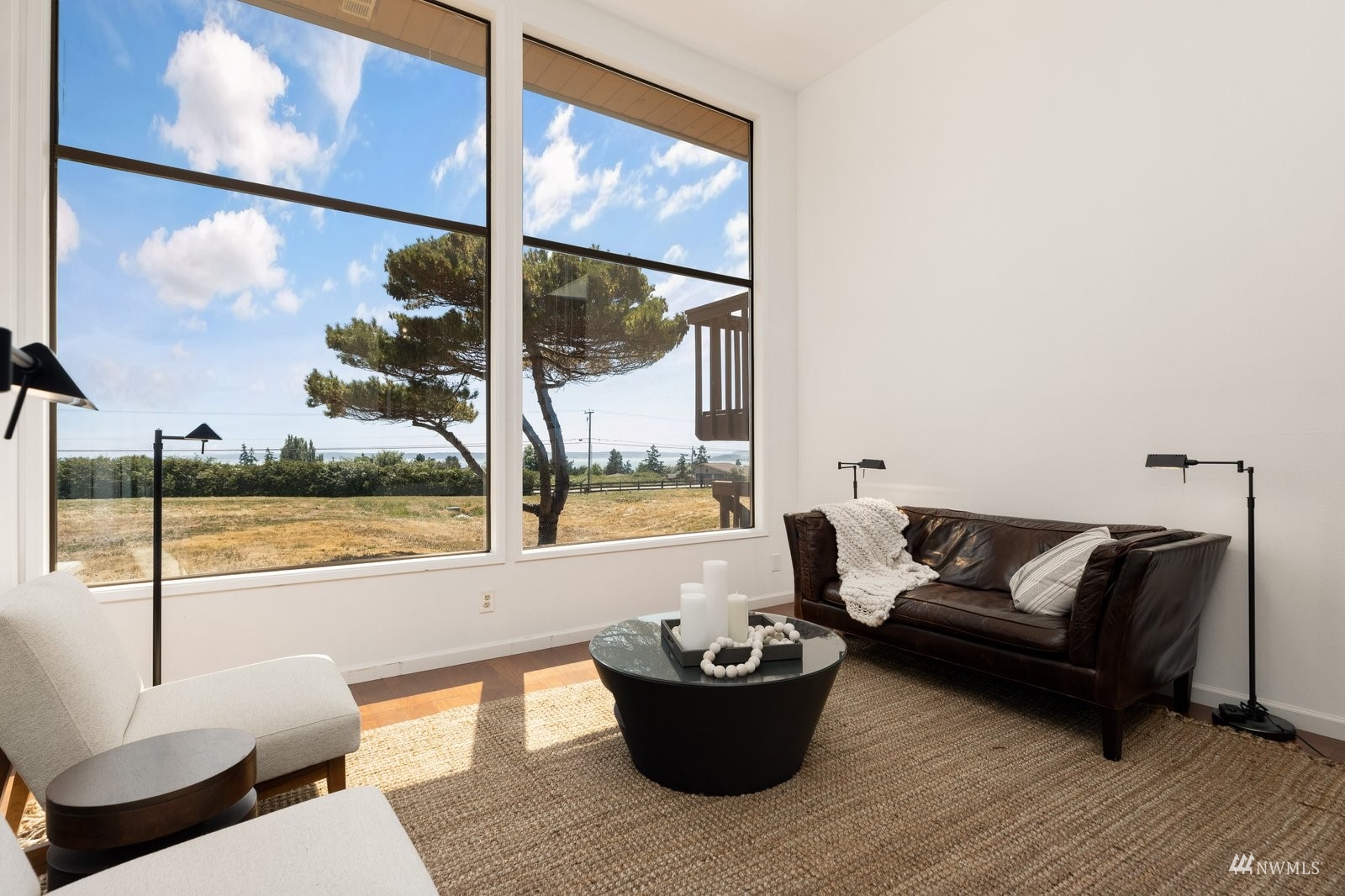 495 East Crescent Harbor Road Oak Harbor, WA 98277 - Photo 6 of 40 a living room with furniture and a floor to ceiling window