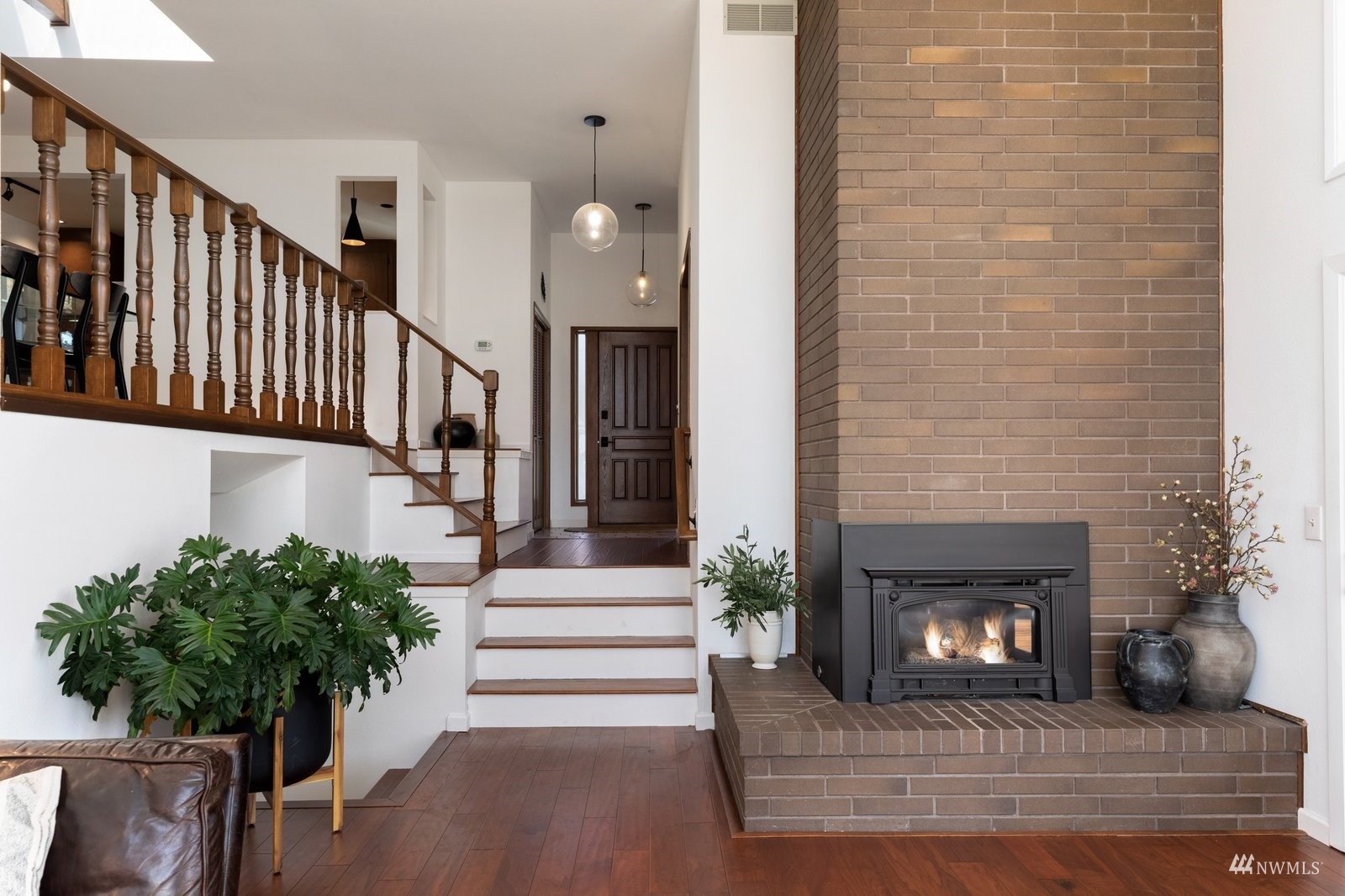 495 East Crescent Harbor Road Oak Harbor, WA 98277 - Photo 7 of 40 a living room with a fireplace and potted plants