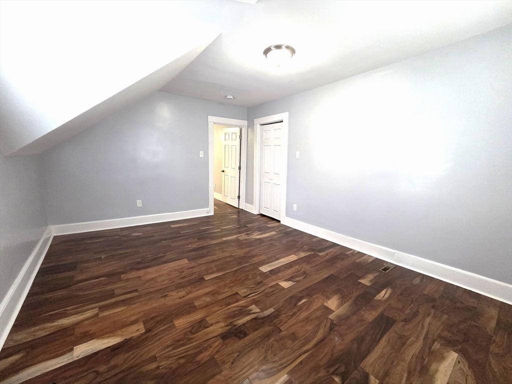 69 Pratt Street, Unit 1 Avon, MA 02322 - Photo 13 of 18 a view of empty room with wooden floor