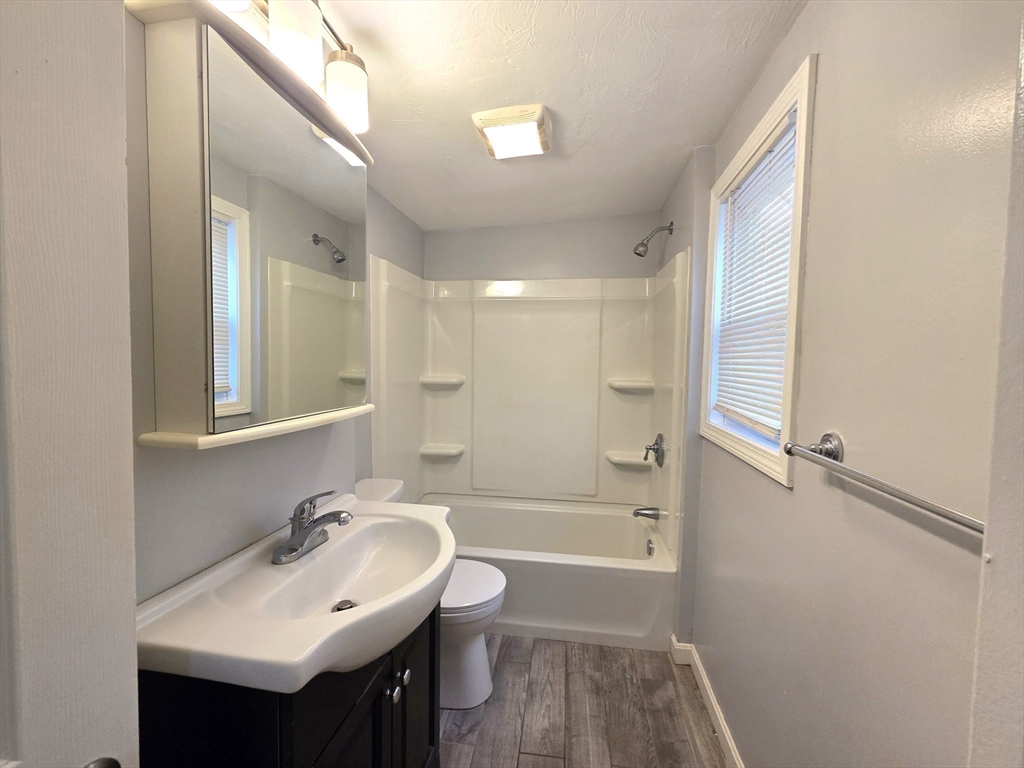 69 Pratt Street, Unit 1 Avon, MA 02322 - Photo 10 of 18 a bathroom with a sink a toilet and shower