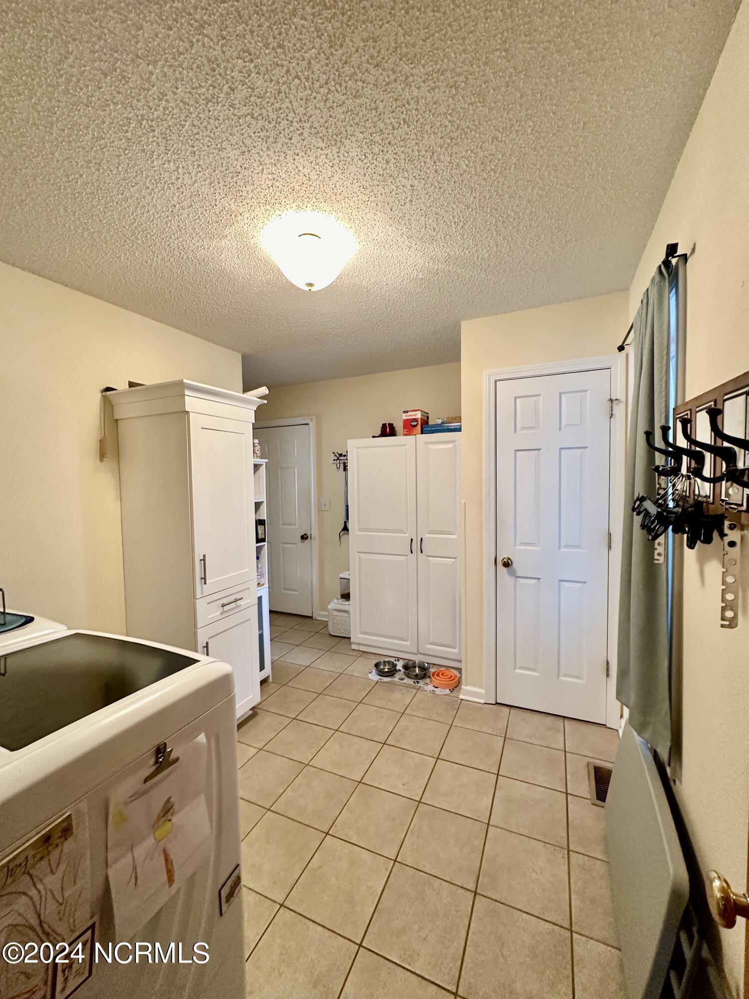1231 Macedonia Road Edenton, NC 27932 - Photo 24 of 55 From the kitchen, past the half bath is the laundry room, office, attic stairs and garage access.