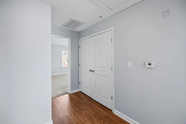 a view of a hallway with wooden floor