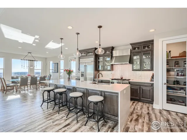 a large kitchen with a table and chairs