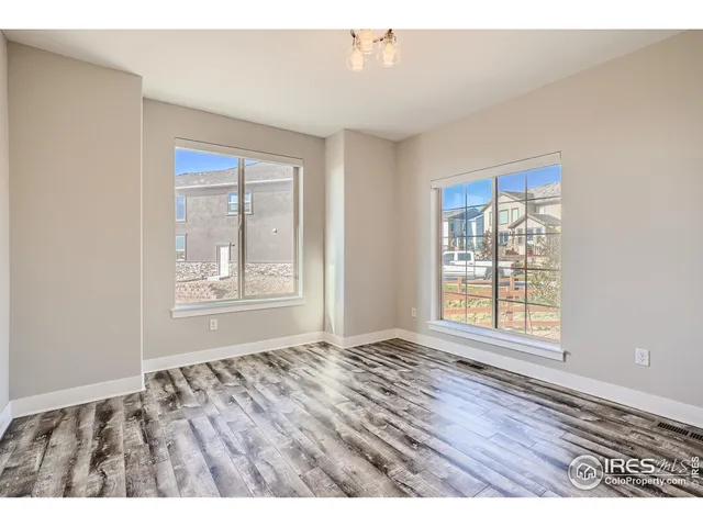 a view of a livingroom with furniture window and wooden floor