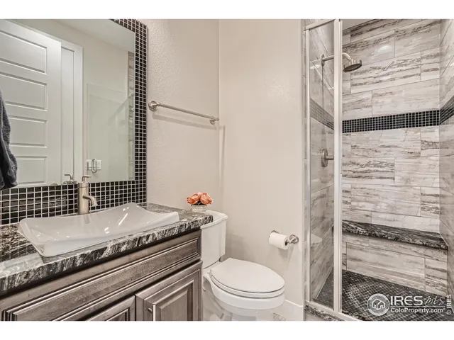 a kitchen with stainless steel appliances granite countertop a refrigerator a stove and a sink with cabinets