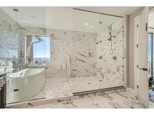 a bathroom with a double vanity sink toilet mirror and bathtub