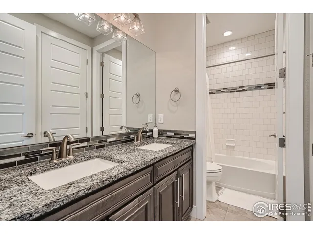 a living room with furniture and a dining table with kitchen view