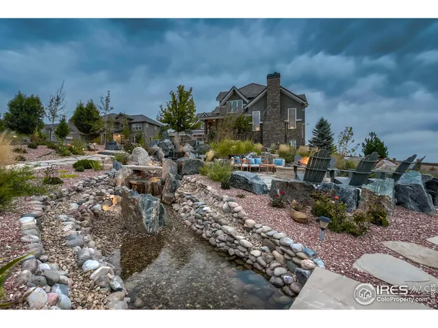 a view of a chairs and table in backyard
