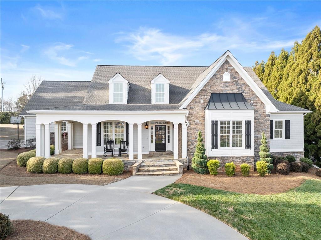 a front view of a house with a garden