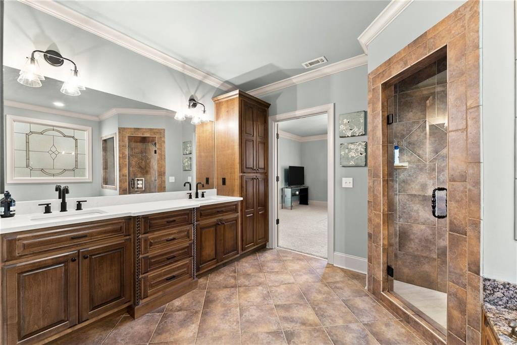 4529 Montclair Circle Gainesville, GA 30506 - Photo 13 of 35 a large bathroom with a sink mirror and shower