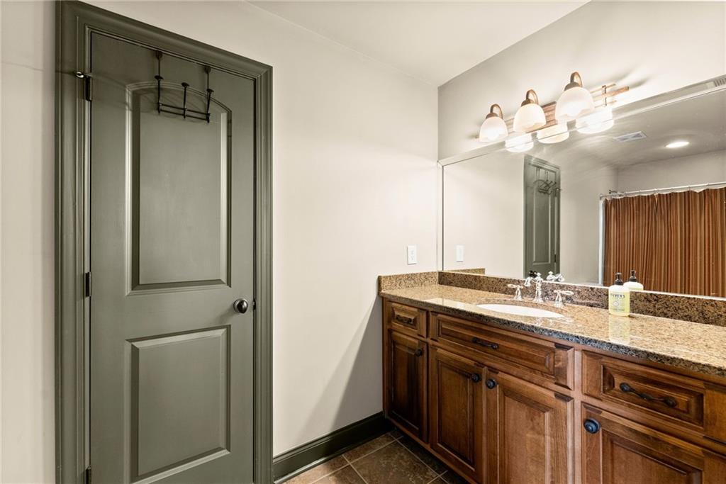 4529 Montclair Circle Gainesville, GA 30506 - Photo 26 of 35 a bathroom with a double vanity sink mirror and shower