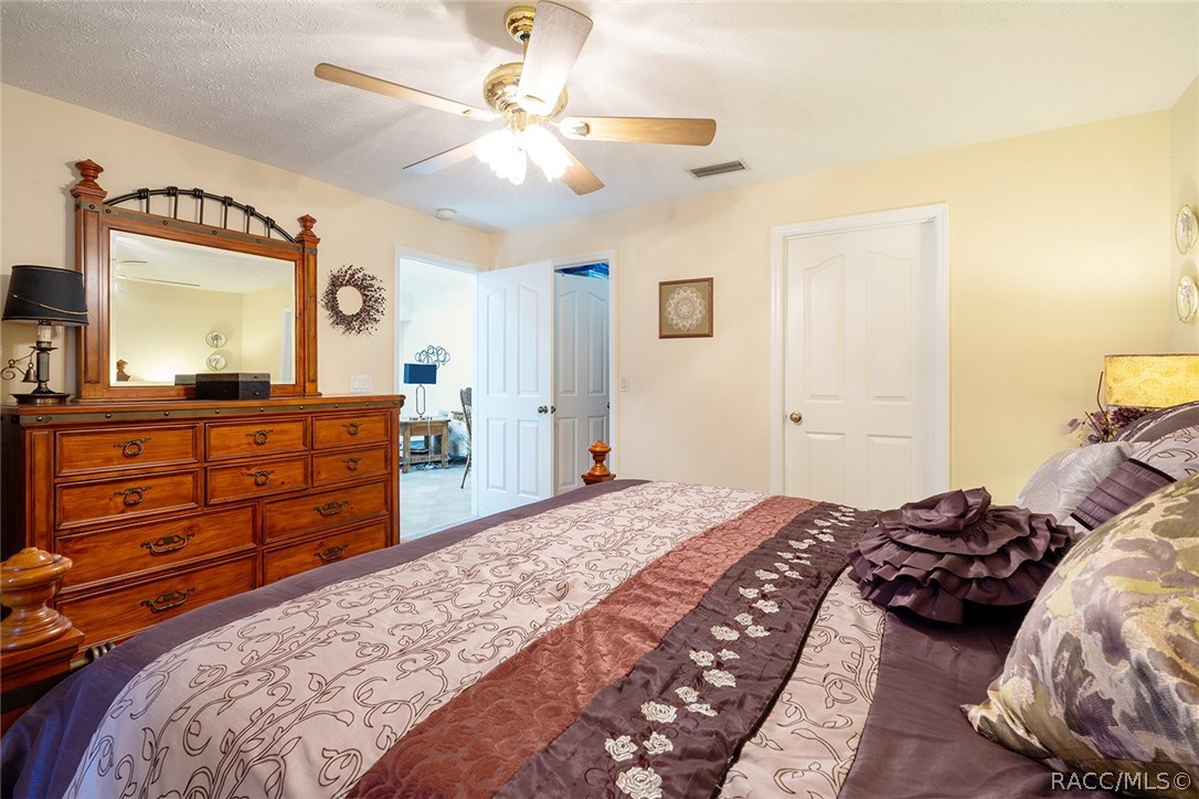 800 Balmoral Court Inverness, FL 34453 - Photo 23 of 72 a bedroom with a bed and a dresser