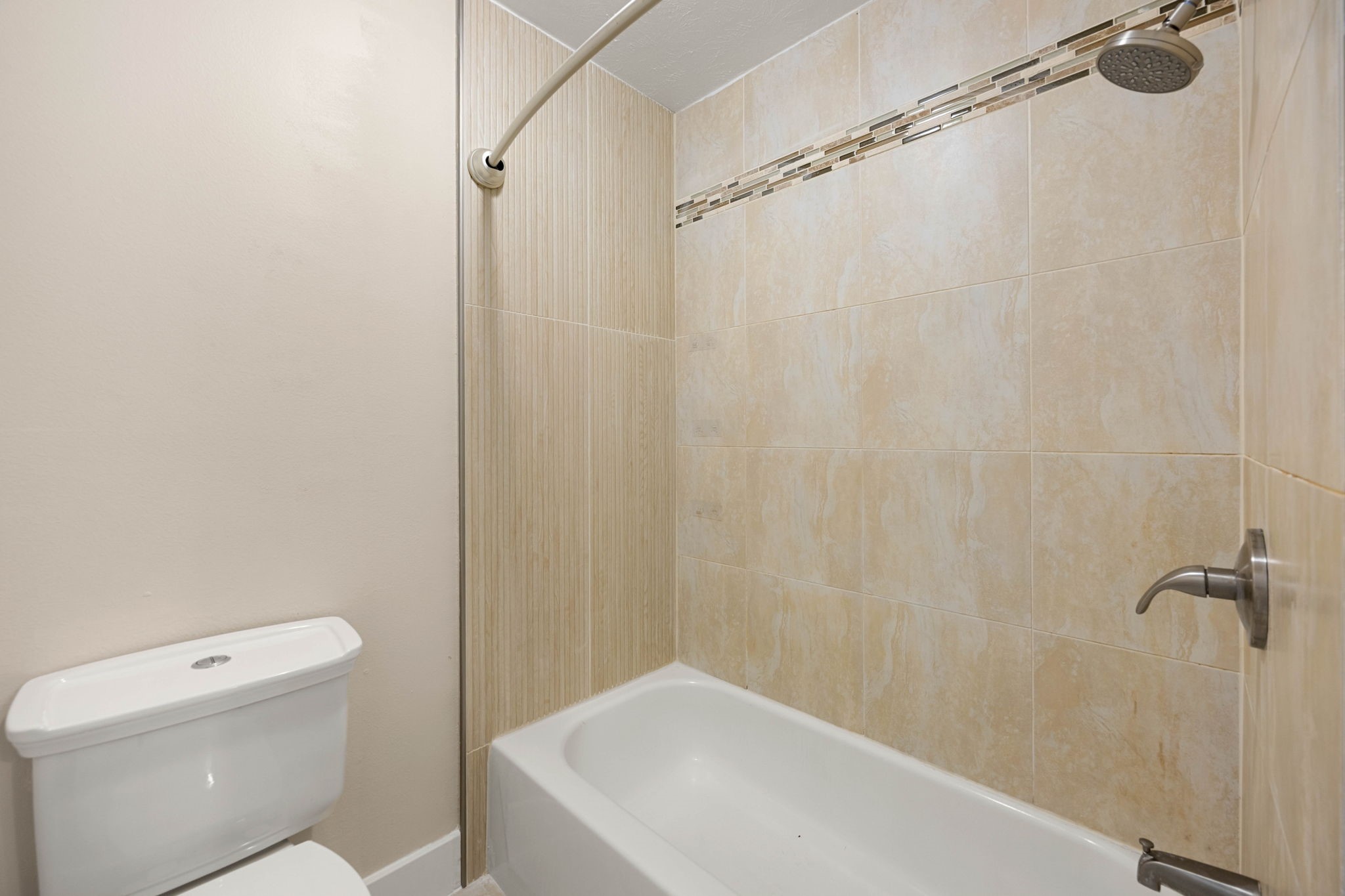 6335 Borg Breakpoint Drive Spring, TX 77379 - Photo 28 of 39 Full bathroom featuring a tub and shower combination with tiled surround.