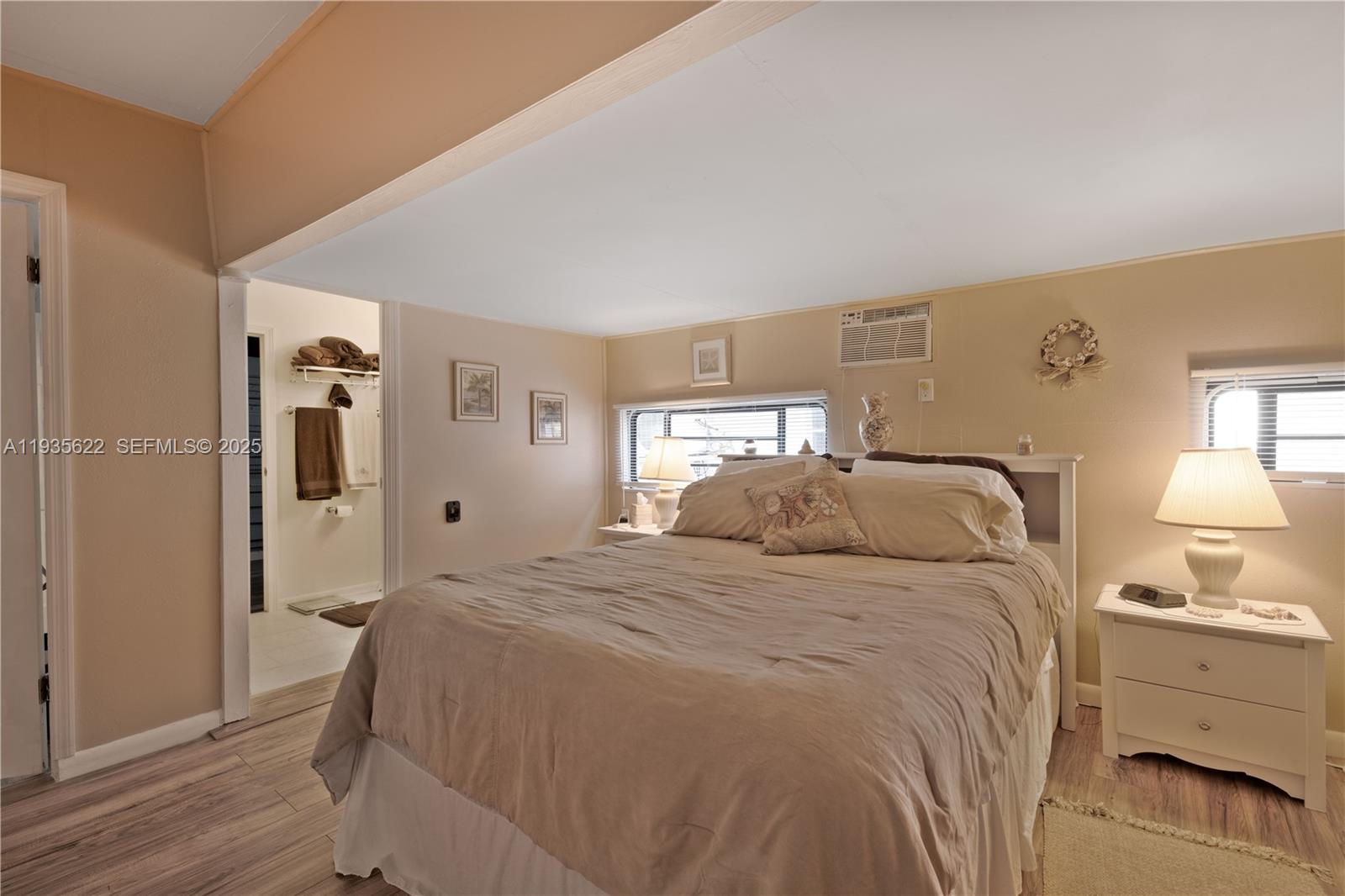 1361 Overseas Highway, Unit E11 Marathon, FL 33050 - Photo 11 of 29 a bedroom with a bed and a lamp