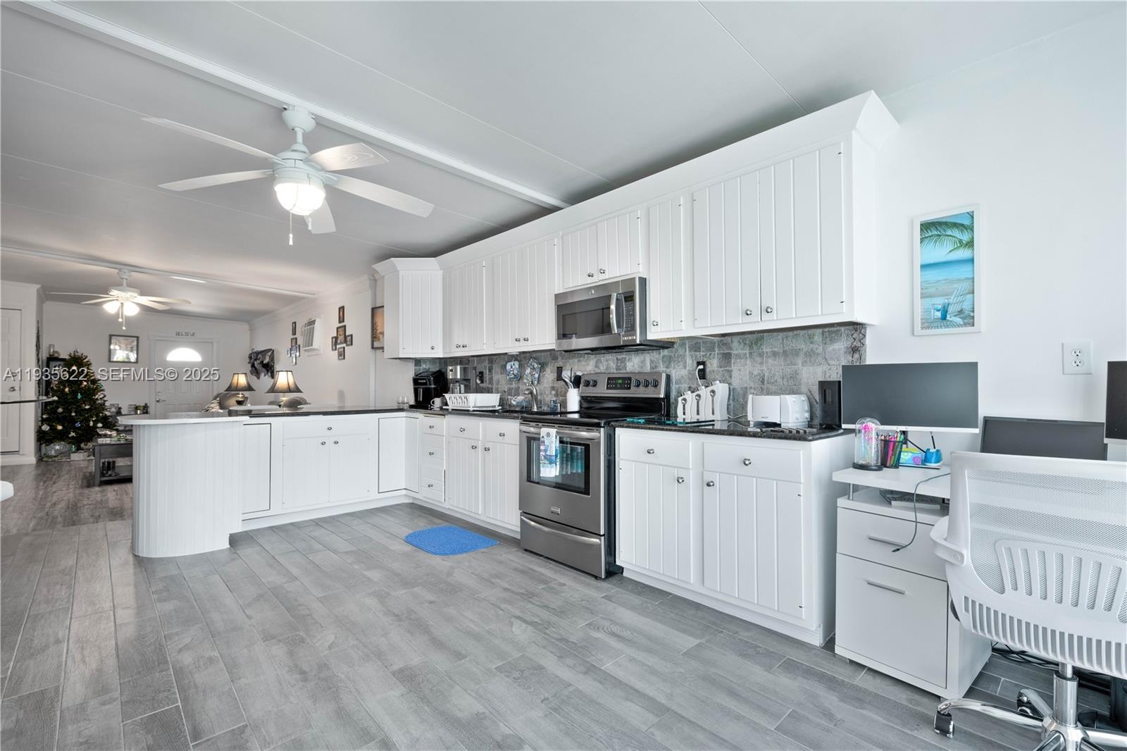 1361 Overseas Highway, Unit E11 Marathon, FL 33050 - Photo 17 of 29 a kitchen with stainless steel appliances white cabinets a sink a stove a refrigerator and white cabinets