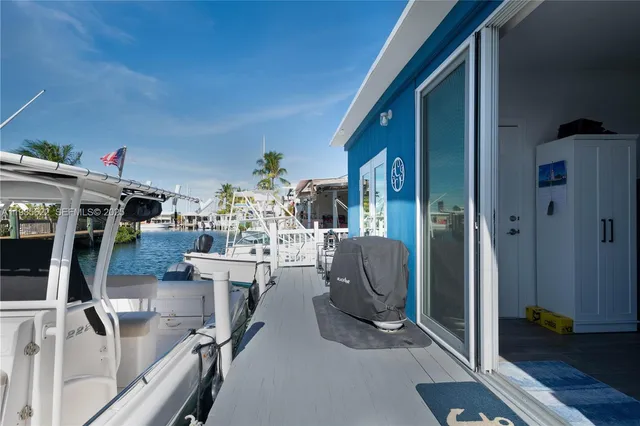 a view of a livingroom with furniture and a floor to ceiling window