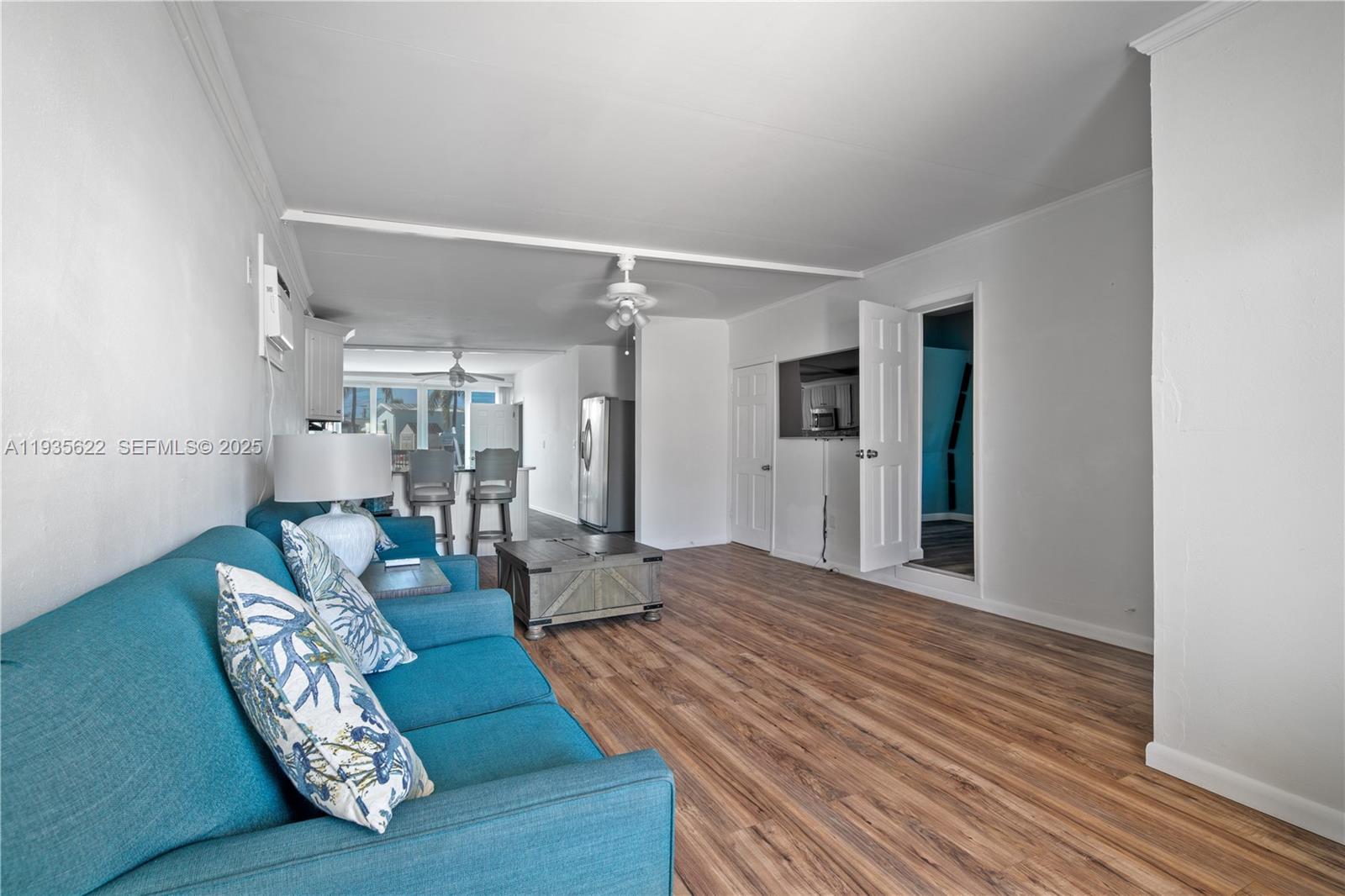 1361 Overseas Highway, Unit E11 Marathon, FL 33050 - Photo 2 of 29 a living room with furniture and a wooden floor