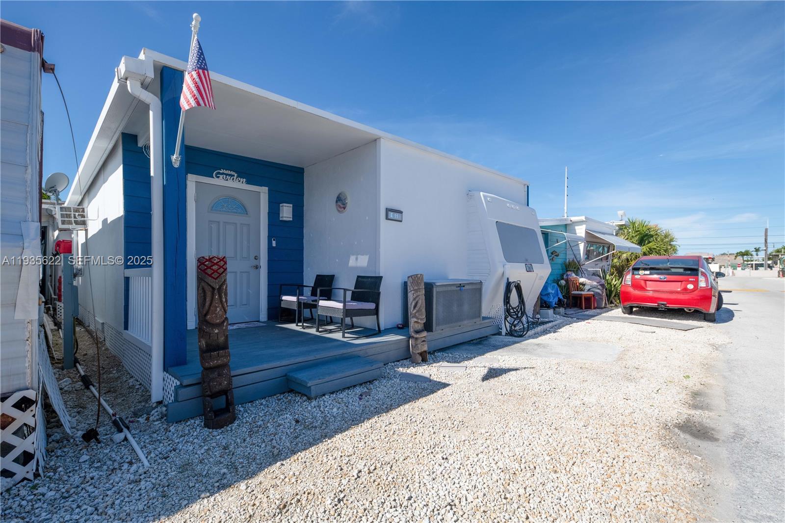 1361 Overseas Highway, Unit E11 Marathon, FL 33050 - Photo 23 of 29 a bedroom with furniture and a flat screen tv