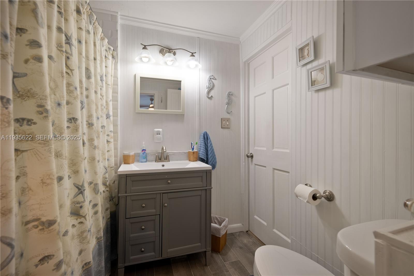 1361 Overseas Highway, Unit E11 Marathon, FL 33050 - Photo 7 of 29 a bathroom with a granite countertop sink toilet a mirror and shower