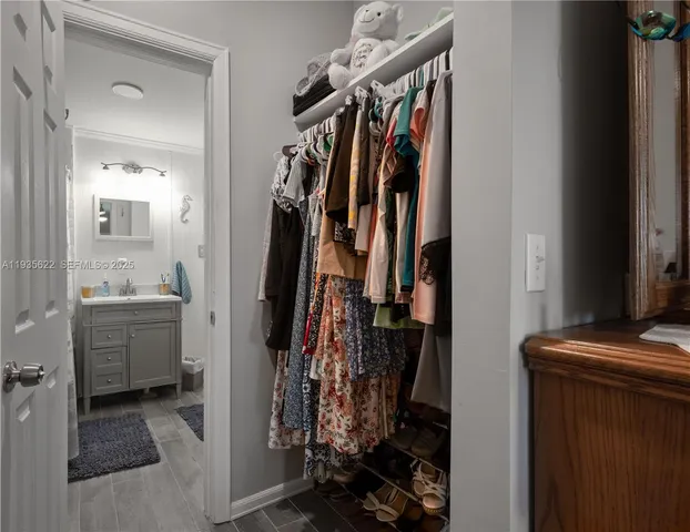 a view of walk in closet with clothes