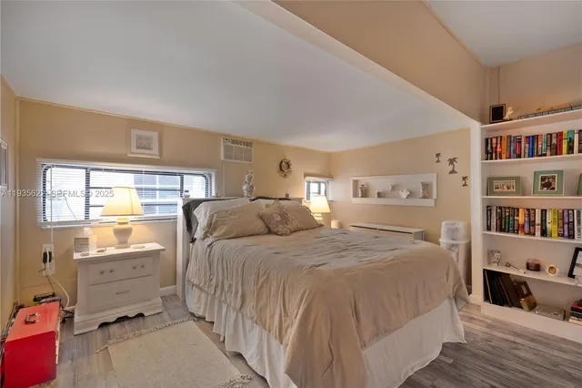a bedroom with a bed and a book shelf