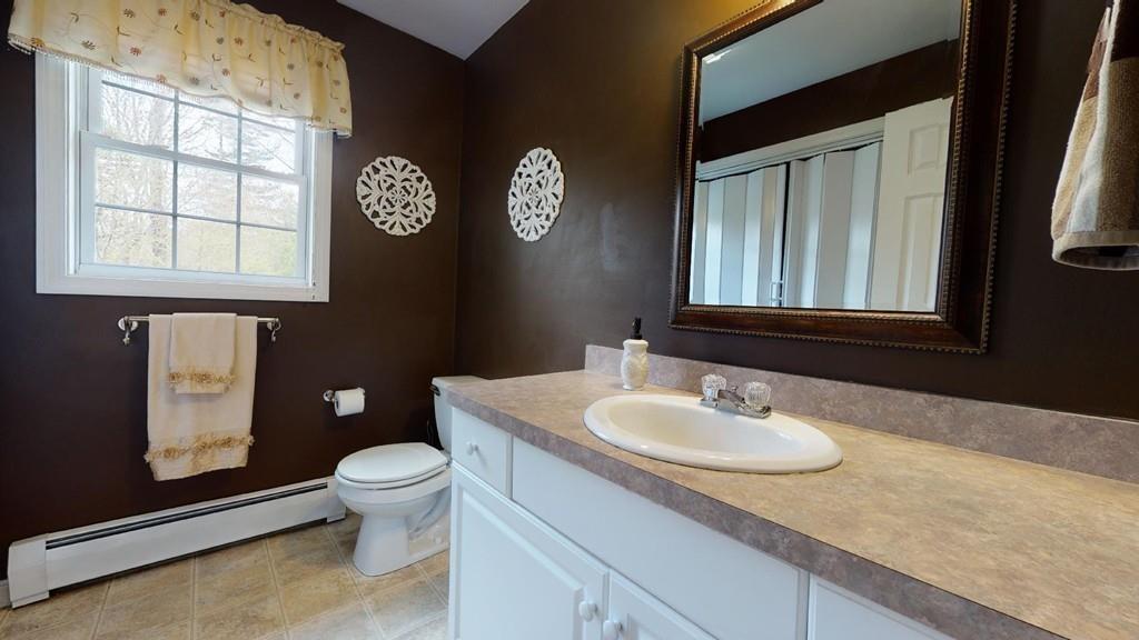 98 Haggerty Road Charlton, MA 01507 - Photo 12 of 42 a bathroom with a granite countertop sink mirror vanity and toilet