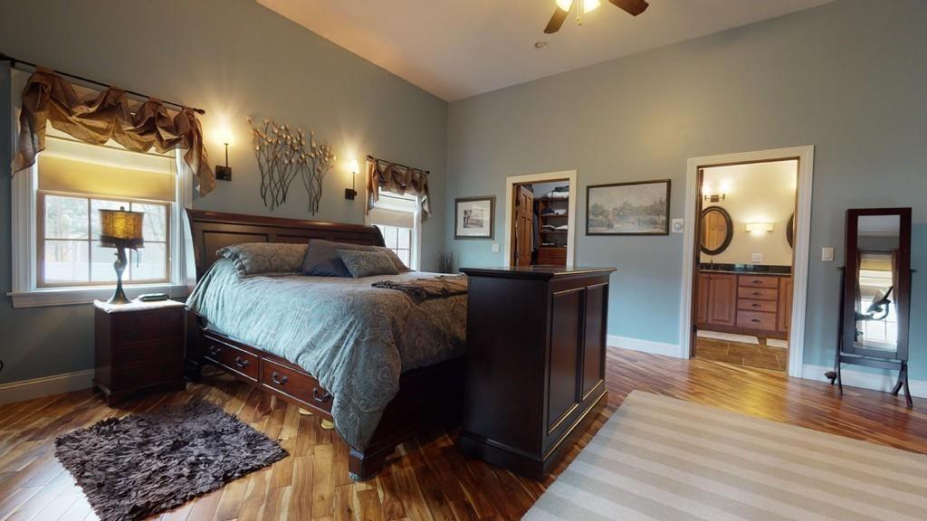 98 Haggerty Road Charlton, MA 01507 - Photo 15 of 42 a bed room with a bed and a lamp