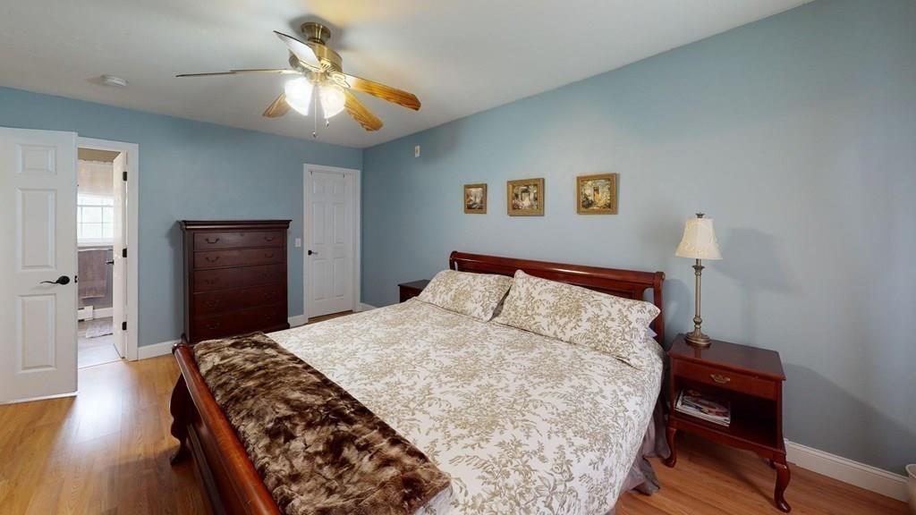 98 Haggerty Road Charlton, MA 01507 - Photo 33 of 42 a bedroom with a bed and wooden floor