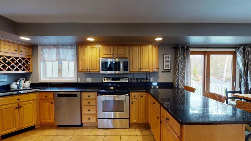 98 Haggerty Road Charlton, MA 01507 - Photo 4 of 42 a kitchen with stainless steel appliances granite countertop a sink a stove counter space and a window