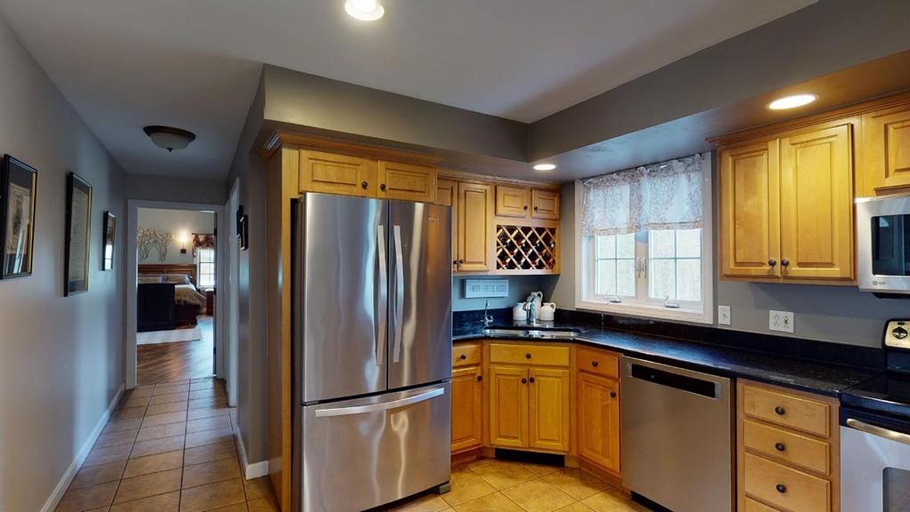 98 Haggerty Road Charlton, MA 01507 - Photo 5 of 42 a kitchen with stainless steel appliances granite countertop a refrigerator and a sink