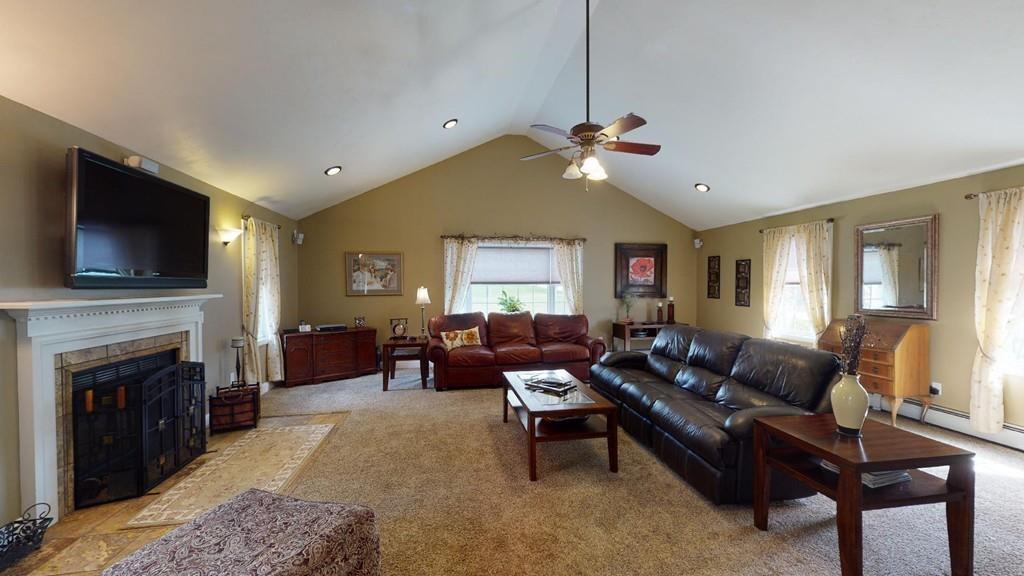 98 Haggerty Road Charlton, MA 01507 - Photo 7 of 42 a living room with furniture fireplace and flat screen tv