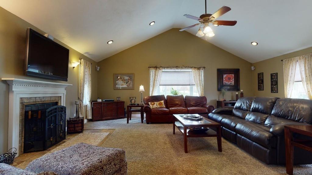 98 Haggerty Road Charlton, MA 01507 - Photo 9 of 42 a living room with furniture a flat screen tv and a fireplace