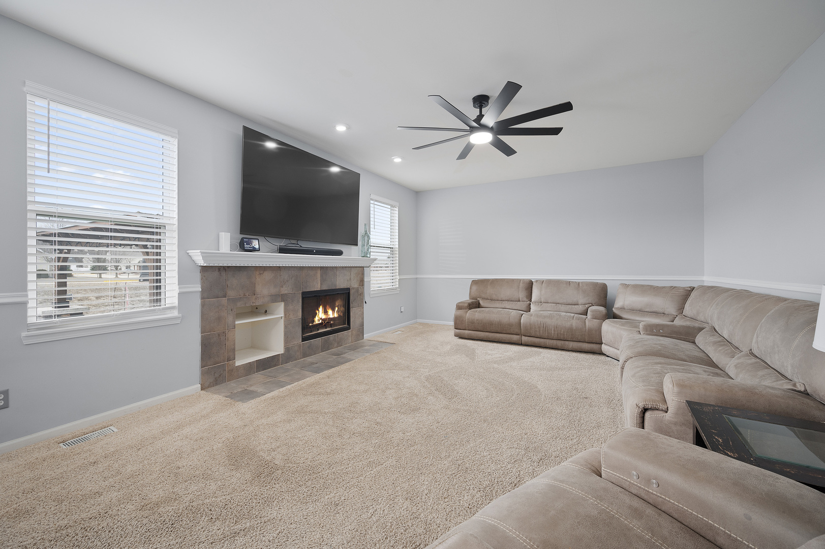 419 Riverbend Drive Genoa, IL 60135 - Photo 11 of 42 a living room with furniture a flat screen tv and a fireplace
