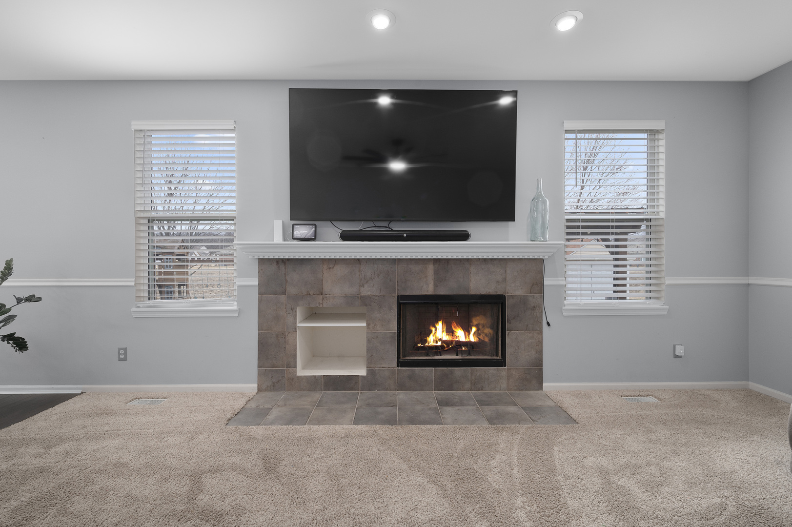 419 Riverbend Drive Genoa, IL 60135 - Photo 12 of 42 a living room with a fireplace and a flat screen tv