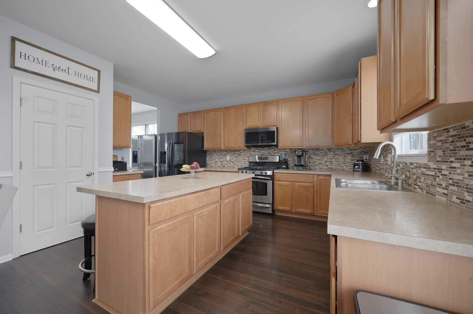 419 Riverbend Drive Genoa, IL 60135 - Photo 9 of 42 a kitchen with kitchen island granite countertop a sink cabinets and stainless steel appliances