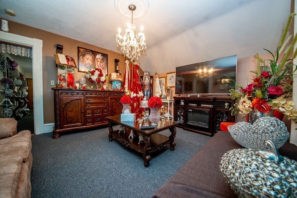 328 Broadway Fall River, MA 02721 - Photo 24 of 29 a living room with furniture and a chandelier