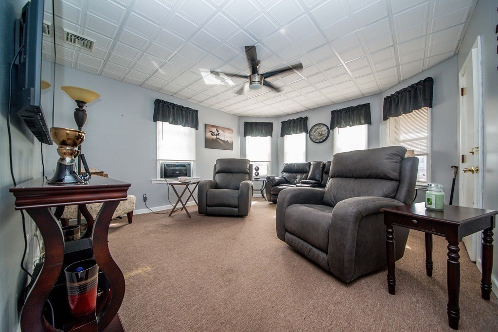 328 Broadway Fall River, MA 02721 - Photo 7 of 29 a living room with furniture a rug and a chandelier