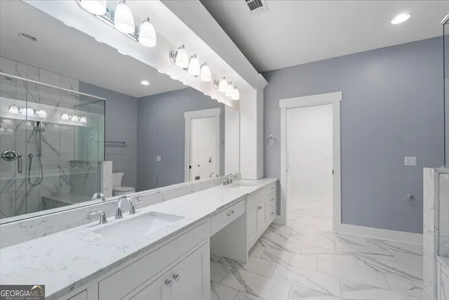 a bathroom with a shower a toilet and sink