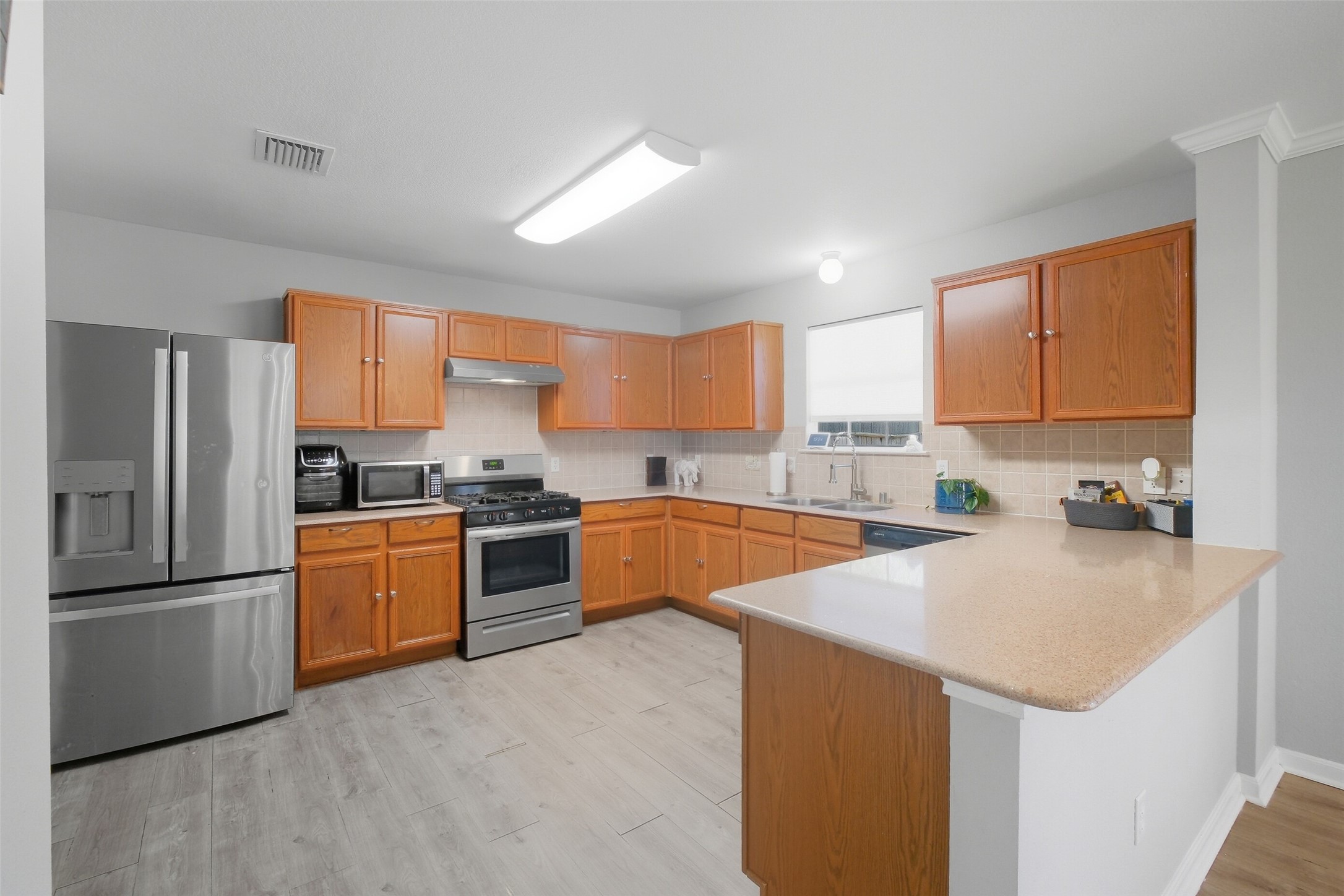 2934 Valiant Scene Court Houston, TX 77038 - Photo 11 of 28 a kitchen with stainless steel appliances granite countertop a refrigerator a stove top oven a sink and dishwasher