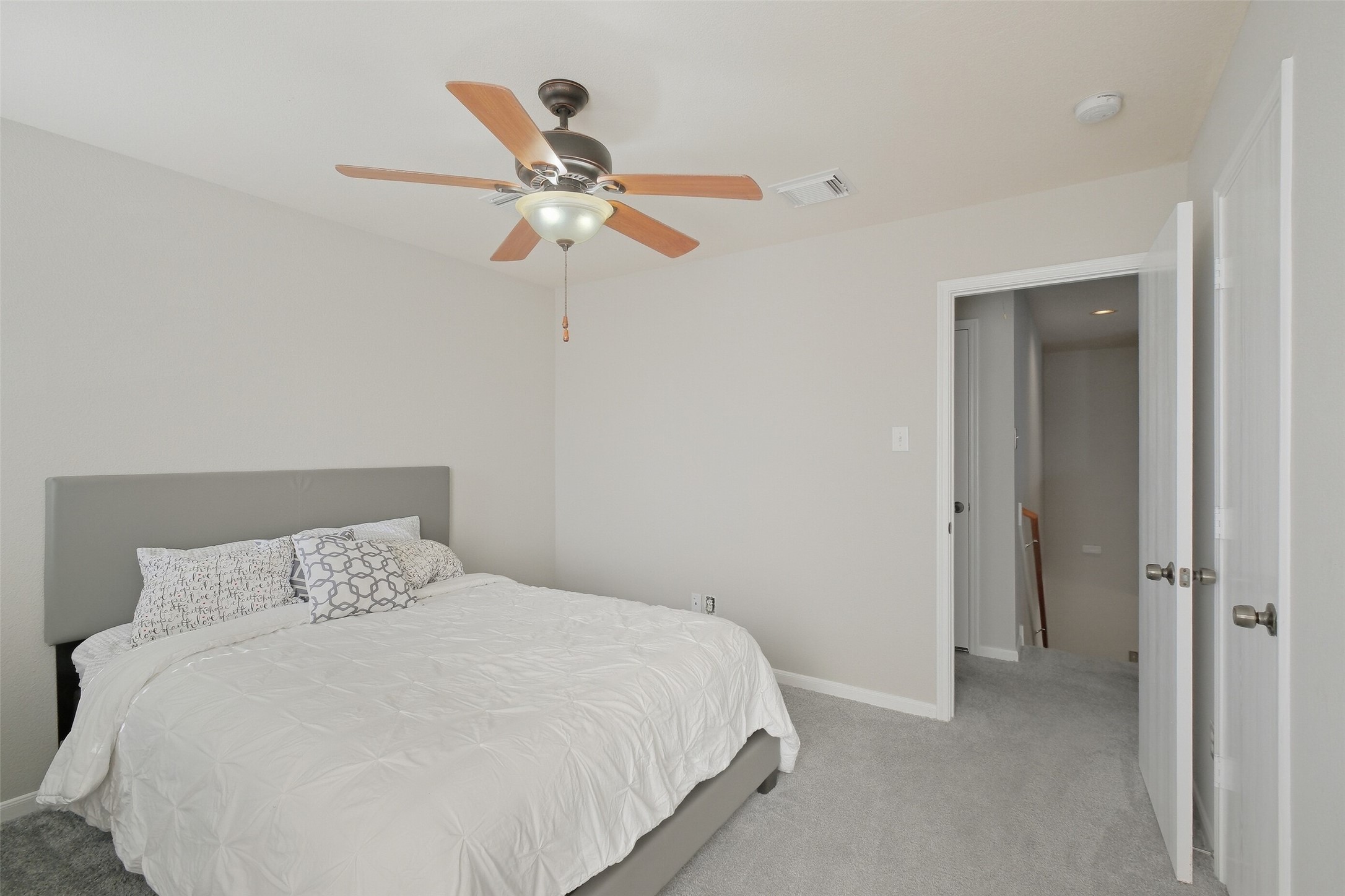 2934 Valiant Scene Court Houston, TX 77038 - Photo 20 of 28 a bedroom with a bed and ceiling fan