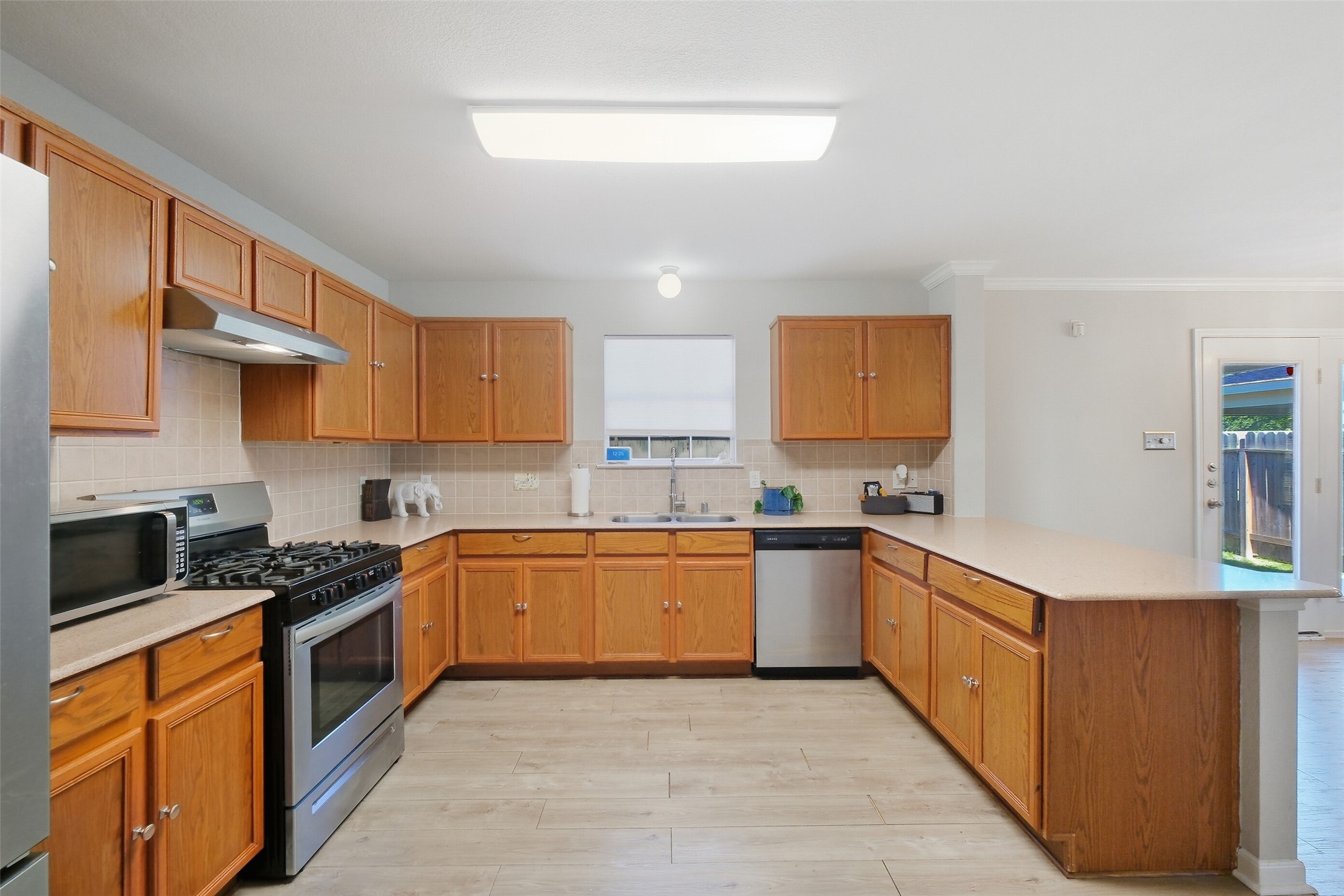 2934 Valiant Scene Court Houston, TX 77038 - Photo 10 of 28 a kitchen with stainless steel appliances granite countertop a stove a sink and a refrigerator