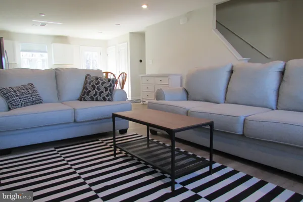 a living room with furniture and a rug